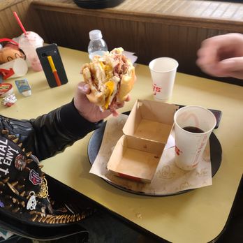 Arby's - a man eating a hot dog - Fast Food Near Me - Burlington, Ontario