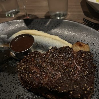 Salt Steakhouse - a steak on a plate with a side of sauce - Kosher Near Me - Long Branch, New Jersey Salt Steakhouse - a steak on a plate with a side of sauce - Kosher Near Me - Long Branch, New Jersey