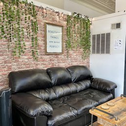 a black leather couch and coffee table