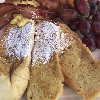 Lucile's Creole Cafe - Pain Perdue (French toast) comes with buttery praline syrup, fruit, one egg and choice of meat. - Cajun/Creole Near Me - Longmont, Colorado