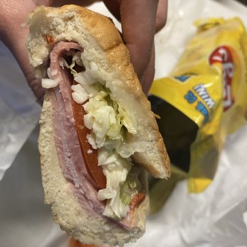 Lil' Pickle USA -  person holding a sandwich - Sandwiches Near Me - Costa Mesa, California