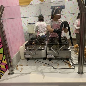 Hello Kitty Cafe - The employees cleaning the cone making machine - Themed Cafes Near Me - Las Vegas, Nevada
