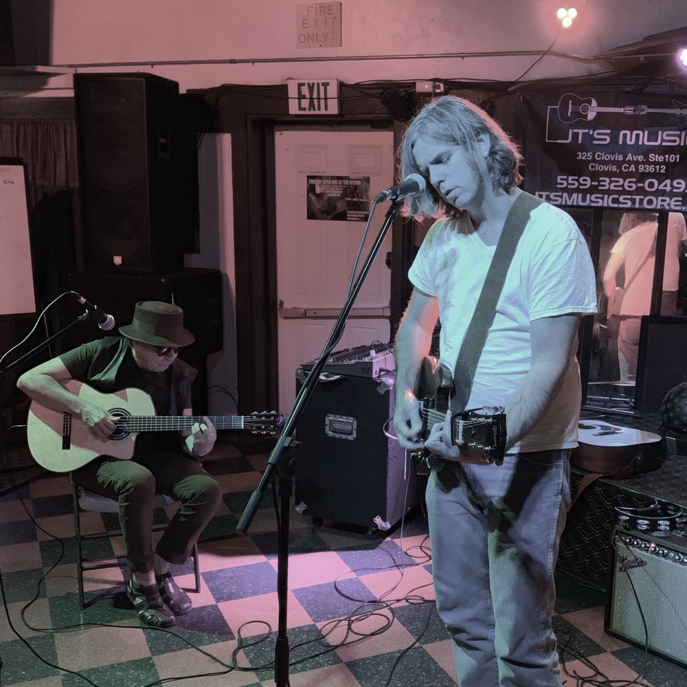 Intimo Cocktail Lounge - a man playing guitar and singing - Cocktail Bars Near Me - Fresno, California