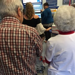 United States Post Office - The line 4 the self serve is ridiculously long. There's an "employee" who is trying to be helping but she's making things worse.