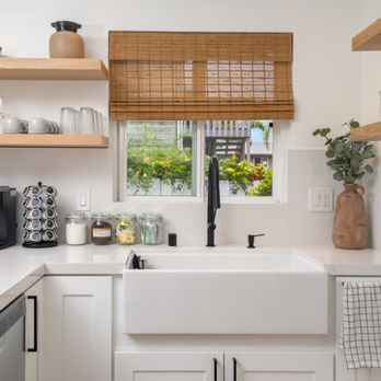 Builders Now - a kitchen with white cabinets and white countertops - General Contractors Near Me - San Diego, California