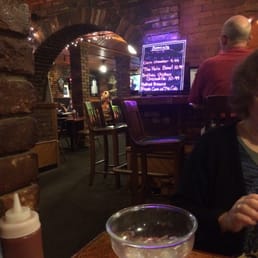 a woman sitting at a table with a glass of wine