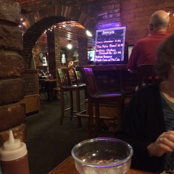 Sheri's Place - a woman sitting at a table with a glass of wine - Mexican Near Me - Springfield, Vermont