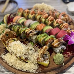 a variety of sushi on a wooden platter a variety of sushi on a wooden platter