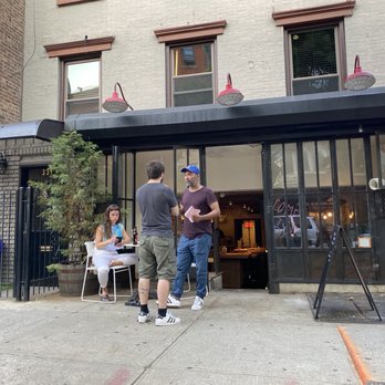 Sauced - The owner chatting it up with a local patron! - Wine Bars Near Me - Brooklyn, New York