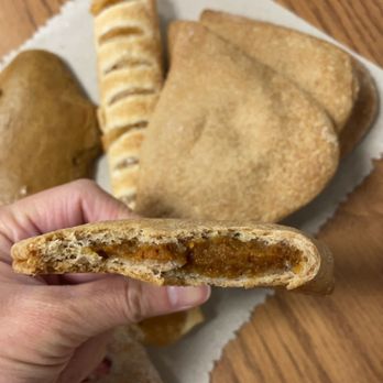El Aguila Bakery - a hand holding a piece of bread - Bakeries Near Me - Fremont, Ohio