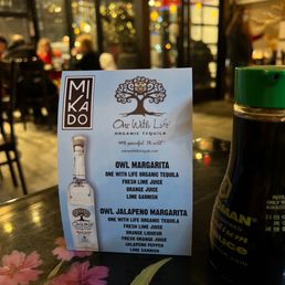 a menu and a bottle of olive margarita a menu and a bottle of olive margarita