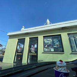 a cup of ice cream in front of a restaurant