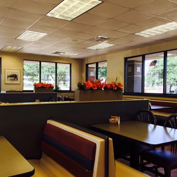 Whataburger - a man sitting at a table in a restaurant - Burgers Near Me - Sugar Land, Texas
