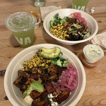 CAVA - two plates of food on a wooden table - Mediterranean Near Me - Los Angeles, California