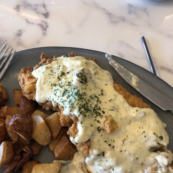 La Belle Vie Kitchen - Smothered pork chop that they just offered for breakfast. - French Near Me - Suwanee, Georgia La Belle Vie Kitchen - Smothered pork chop that they just offered for breakfast. - French Near Me - Suwanee, Georgia