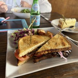 Cheff choise steak sandwich with small salad and potatoes.