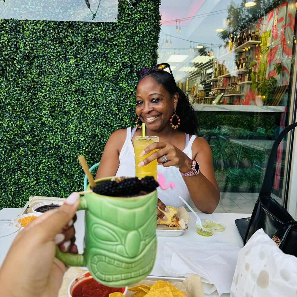 Tikila Tacos & Mezcal - Cute patio with grass wall and neon sign - Mexican Near Me - Wake Forest, North Carolina Tikila Tacos & Mezcal - Cute patio with grass wall and neon sign - Mexican Near Me - Wake Forest, North Carolina