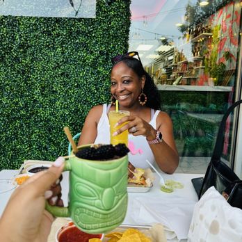 Tikila Tacos & Mezcal - Cute patio with grass wall and neon sign - Mexican Near Me - Wake Forest, North Carolina Tikila Tacos & Mezcal - Cute patio with grass wall and neon sign - Mexican Near Me - Wake Forest, North Carolina
