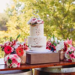 Swirlz Bakeshop - Custom Semi-Naked Wedding Cake with silk florals and edible rose gold flakes.