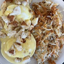 a plate of food with eggs and hash browns
