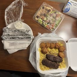 Beef kabobs with salad, falafels on the side & peta bread.