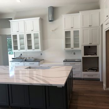 MasterCraft Builders - a kitchen with white cabinets and marble countertops - General Contractors Near Me - Laguna Hills, California MasterCraft Builders - a kitchen with white cabinets and marble countertops - General Contractors Near Me - Laguna Hills, California