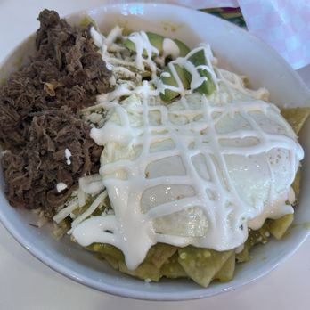 Cafecito - Chilaquiles topped with green salsa, two eggs over medium and a side of barbacoa - Mexican Near Me - Fort Worth, Texas Cafecito - Chilaquiles topped with green salsa, two eggs over medium and a side of barbacoa - Mexican Near Me - Fort Worth, Texas