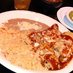 Enchiladas with rice and refried beans.