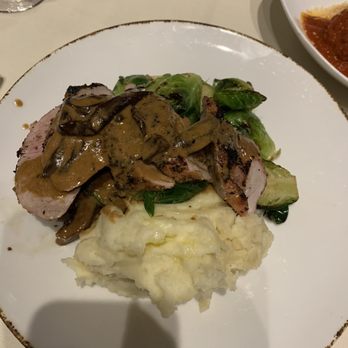 Delfinos Italian Restaurant - Pork loin with a mushroom cream sauce, mashed potatoes, and Brussels sprouts - Italian Near Me - Palm Coast, Florida