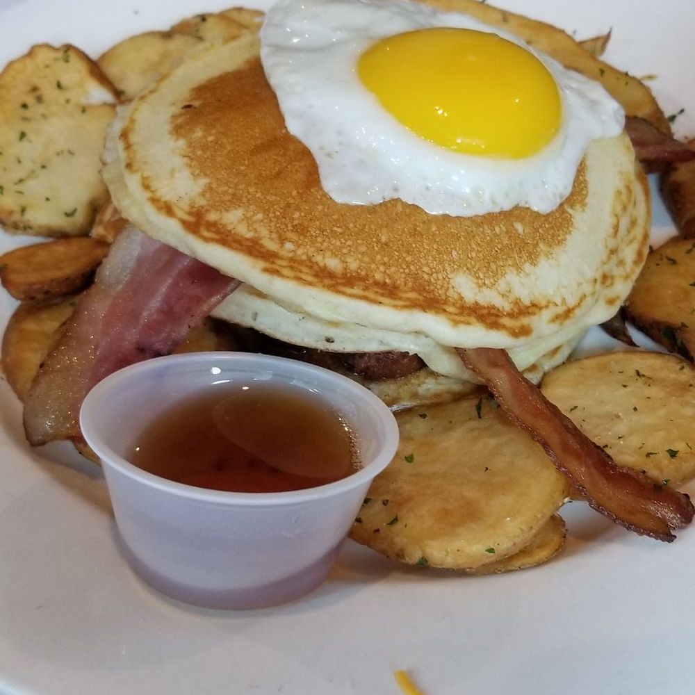 Eggspectation - Maisonneuve - High Rise Pancakes with layer of sausage, bacon and topped with the egg - Breakfast & Brunch Near Me - Montreal, Quebec Eggspectation - Maisonneuve - High Rise Pancakes with layer of sausage, bacon and topped with the egg - Breakfast & Brunch Near Me - Montreal, Quebec