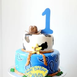 Blue Cake House - Cowboy theme birthday cake. #bluecakehouse #bakingyourdreamscometrue #barn #birthdaycake #cow #lasso #bandana #buttercream #fondant #pastel