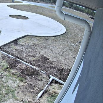 Rain Tech Gutter Solutions - Downspout placed right in front of Security Camera - Gutter Services Near Me - Liberty hill, Texas