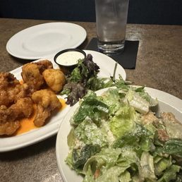 Tonight's light dinner of buffalo cauliflower bites and a side Caesar salad. Tonight's light dinner of buffalo cauliflower bites and a side Caesar salad.