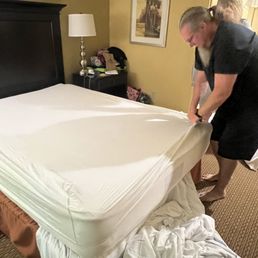 Trying to get the sheet to fit, they made the bed and left it loose! Trying to get the sheet to fit, they made the bed and left it loose!