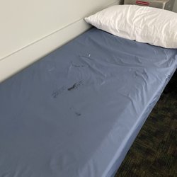 North American Emergency Medical Center - Blood stained sheets in a "clean" exam room. Repulsive.