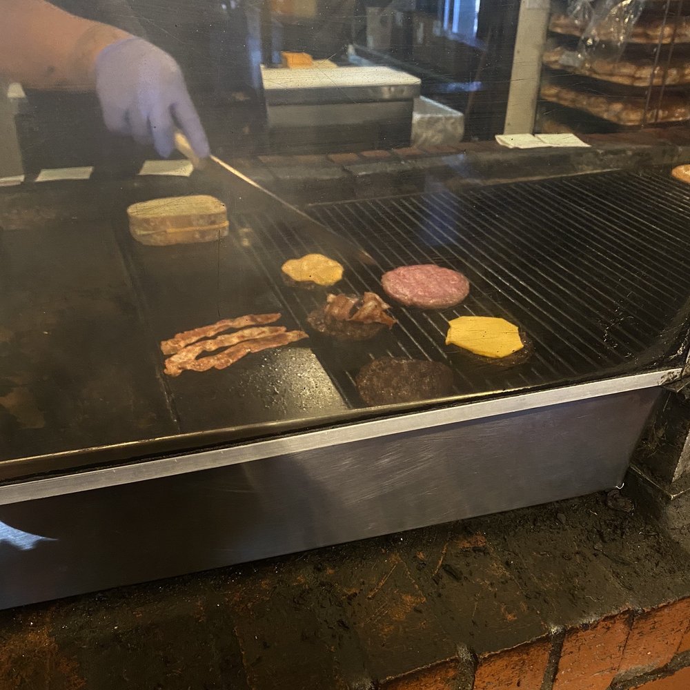Bun Huggers - a man cooking hamburgers on a grill - Burgers Near Me - Flagstaff, Arizona Bun Huggers - a man cooking hamburgers on a grill - Burgers Near Me - Flagstaff, Arizona