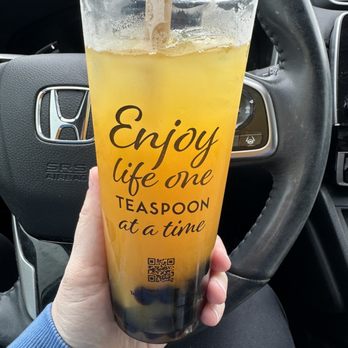 Teaspoon - a person holding a drink in their hand - Tea Rooms Near Me - Deerfield Beach, Florida