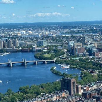 View Boston - A high-angle view of Boston, showing the Charles River, the Longfellow Bridge, and the city skyline with various buildings and green spaces. - Observatories Near Me - Boston, Massachusetts