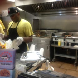 Sharks Fish & Chicken Too - Food being fried.