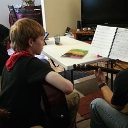 Guitar Confidence - Helping a father and son go over timing and reading music.
