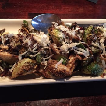 Parma Tavern - Crispy Brussels sprout. The cheese and candied bacon paired well with sprouts and dressing - Italian Near Me - Buford, Georgia Parma Tavern - Crispy Brussels sprout. The cheese and candied bacon paired well with sprouts and dressing - Italian Near Me - Buford, Georgia