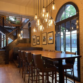 Bleuroot - a dining room with a long table and chairs - New American Near Me - West Dundee, Illinois