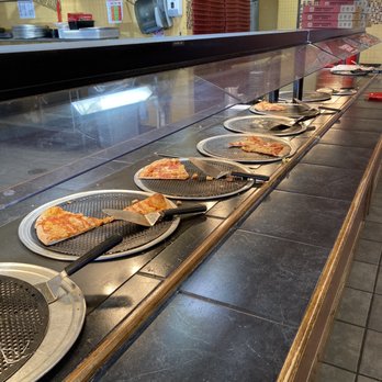 Cicis Pizza - a row of pizzas on a counter - Pizza Near Me - Coppell, Texas