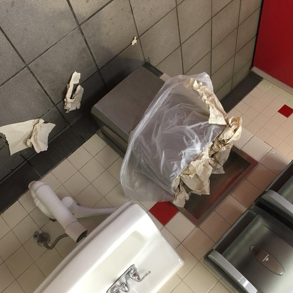 Chuck E. Cheese - a toilet and trashcan in a public restroom - Pizza Near Me - Olympia, Washington