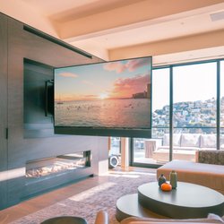 SoundVision - This massive 85" TV fits into a TV niche for the living room, but swings out an entire 90 degrees to face the kitchen!