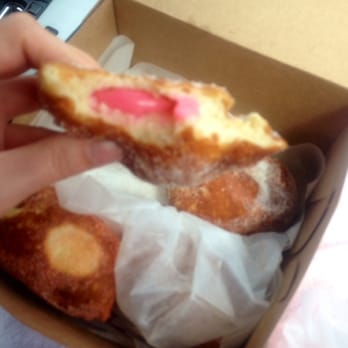 Leonard's Bakery - Box of malasadas, with a hot pink guava malasada on top! - Bakeries Near Me - Honolulu, Hawaii Leonard's Bakery - Box of malasadas, with a hot pink guava malasada on top! - Bakeries Near Me - Honolulu, Hawaii
