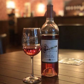 Saviana Winery - a wine glass and a bottle on a table - Wineries Near Me - Cedar Hill, Texas
