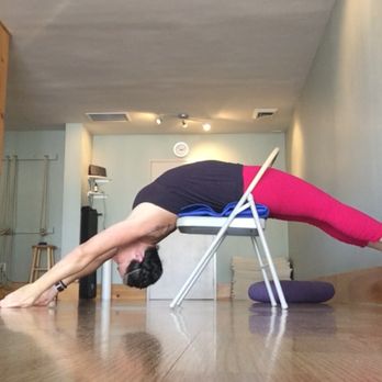 Bliss Wellness by Kat - Kat doing backbend in a chair. - Yoga Near Me