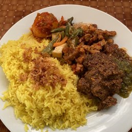 You can pick whatever toppings you want In this pic: Nasi Kuning (yellow rice) -telor balado -rendang -tempe manis -sayur buncis You can pick whatever toppings you want In this pic: Nasi Kuning (yellow rice) -telor balado -rendang -tempe manis -sayur buncis