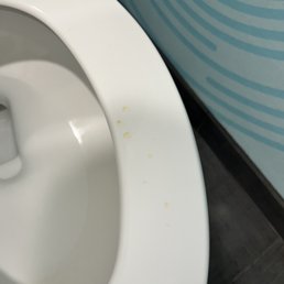 Toilet seat with dried up pee.